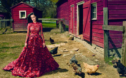 HD desktop wallpaper featuring Katy Perry in a red floral dress standing outside a red barn with chickens. The scene blends rustic farm life with a touch of glamour.