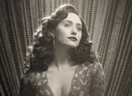 Black and white HD desktop wallpaper featuring celebrity Emmy Rossum with vintage waves and glamorous attire against a textured curtain backdrop.