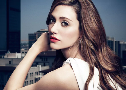 HD PC desktop wallpaper featuring a close-up portrait of Emmy Rossum against an urban rooftop backdrop.