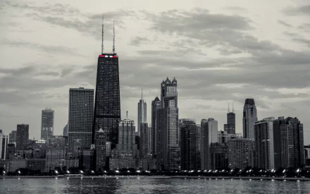 Black and white HD desktop wallpaper featuring the iconic man-made Chicago skyline under a cloudy sky by the water.