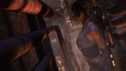 HD PC desktop wallpaper featuring Lara Croft from Tomb Raider (2013) in a dimly lit, industrial environment, showcasing the video game's atmospheric design.