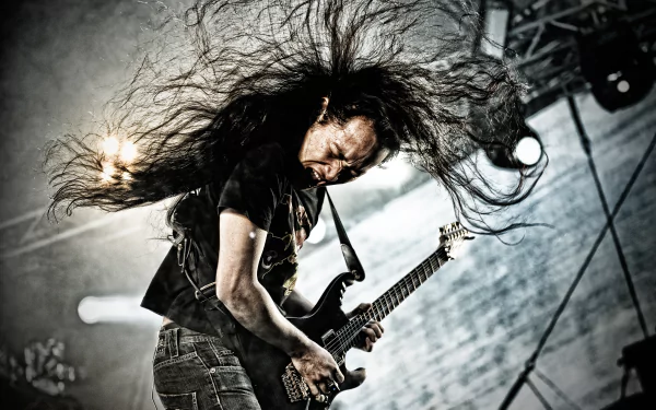A dynamic 4K Ultra HD wallpaper featuring a musician passionately playing guitar with long hair flying, capturing the energy of a DragonForce performance.