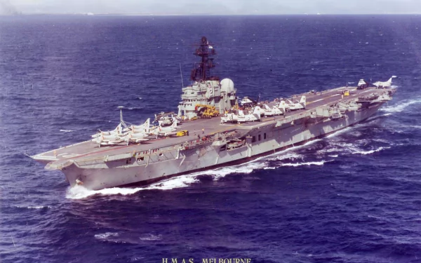 HD desktop wallpaper featuring the military aircraft carrier HMAS Melbourne (R21) sailing through calm ocean waters.