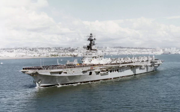 HD PC desktop wallpaper showing the military aircraft carrier HMAS Melbourne (R21) underway at sea — a warship with flight deck and superstructure against a coastal skyline.