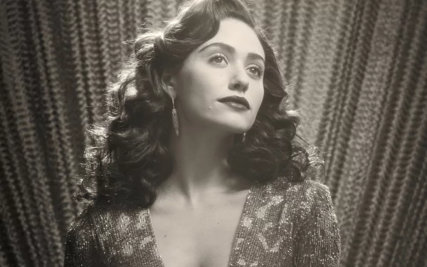 Black and white HD desktop wallpaper featuring celebrity Emmy Rossum with vintage waves and glamorous attire against a textured curtain backdrop.
