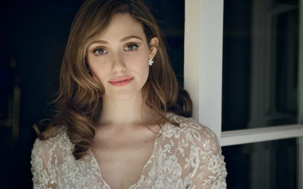 A beautiful HD desktop wallpaper featuring actress Emmy Rossum, showcasing her elegant style and captivating expression against a softly lit background.