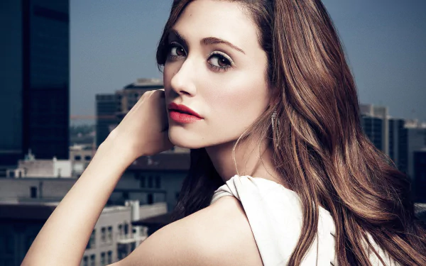 HD PC desktop wallpaper featuring a close-up portrait of Emmy Rossum against an urban rooftop backdrop.