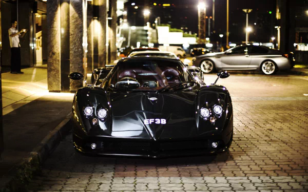 HD desktop wallpaper featuring a Pagani Zonda on a city street at night, highlighted by urban lighting.