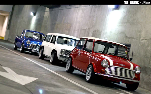 HD PC desktop wallpaper: three classic Mini Cooper vehicles — red, white and blue — lined up in a concrete tunnel.
