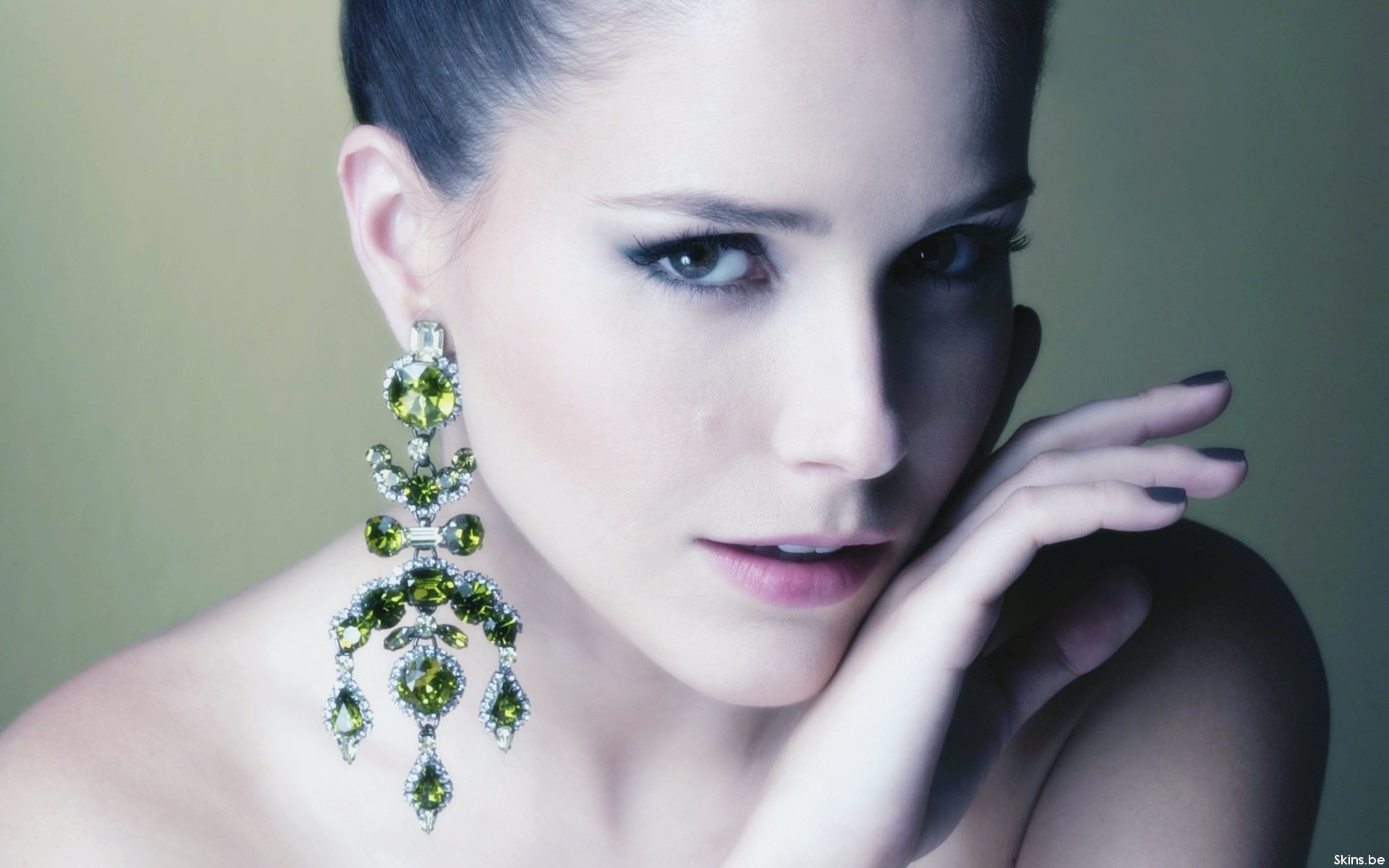 HD PC desktop wallpaper featuring celebrity Sophia Bush with elegant makeup and large, ornate green and gold earrings against a soft, muted background.