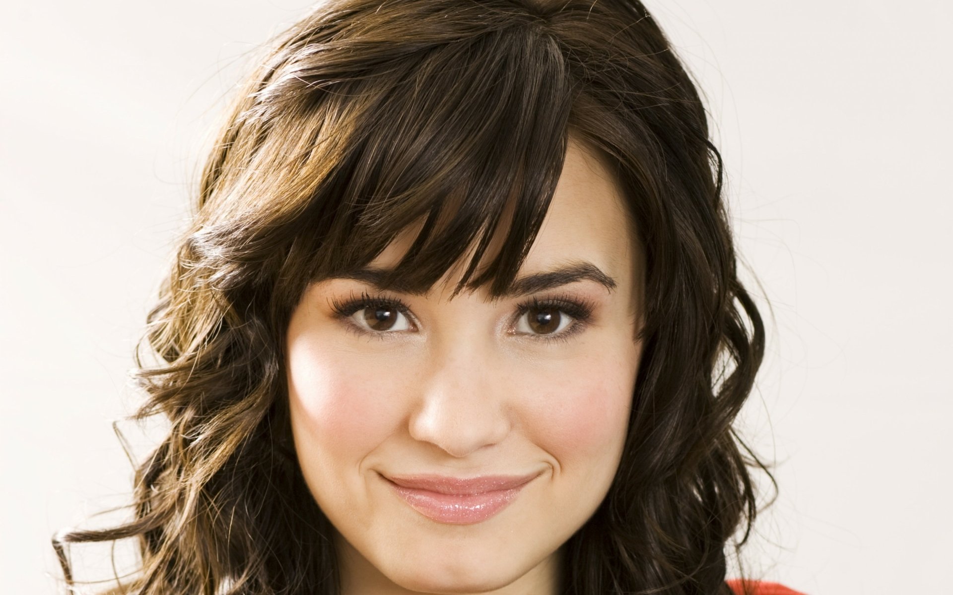 HD PC desktop wallpaper featuring a close-up portrait of Demi Lovato with soft lighting, highlighting her natural expression in a music-themed image.