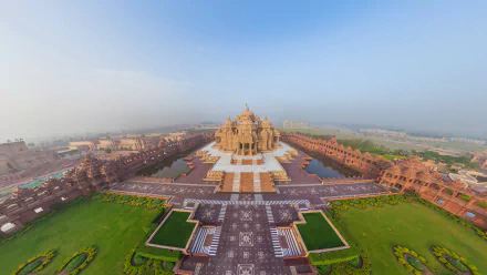 A stunning HD wallpaper featuring the majestic Akshardham temple, surrounded by lush gardens and intricate pathways, capturing the beauty of this religious landmark.