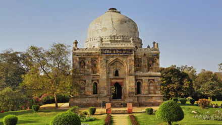 HD PC desktop wallpaper featuring a historic religious temple with intricate stone architecture surrounded by lush greenery under a clear sky.