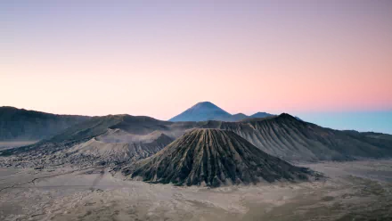 A stunning HD wallpaper of Mount Bromo, showcasing its majestic volcanic landscape against a gradient sky, capturing the beauty of nature in a serene setting.