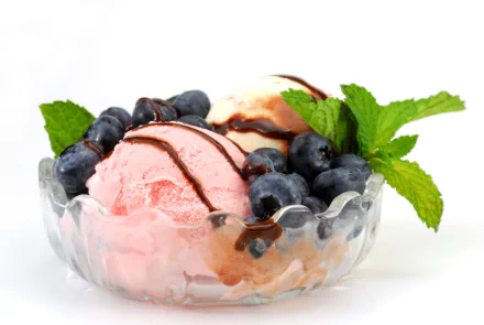 A vibrant bowl of pink ice cream topped with chocolate drizzle, fresh blueberries, and mint leaves, creating a delightful and refreshing food-themed HD desktop wallpaper.