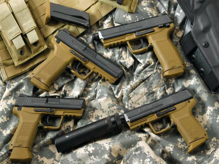 HD desktop wallpaper featuring multiple Heckler & Koch pistols arranged on military camouflage fabric.