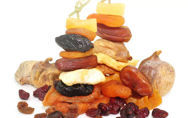 A vibrant stack of assorted dried fruits including apricots, figs, dates, and cranberries showcased in a 4K Ultra HD PC desktop wallpaper and background.