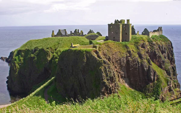 A stunning view of Dunnottar Castle, perched on a dramatic cliff overlooking the sea, captured in high-definition, making it an impressive PC desktop wallpaper and background.