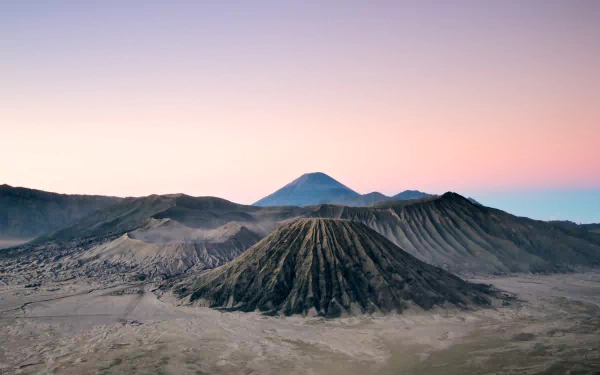 A stunning HD wallpaper of Mount Bromo, showcasing its majestic volcanic landscape against a gradient sky, capturing the beauty of nature in a serene setting.