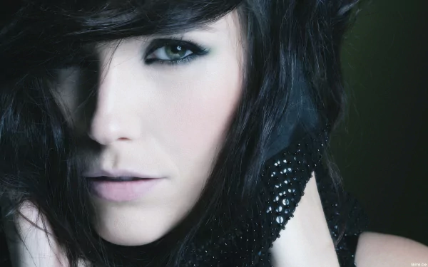 HD PC desktop wallpaper featuring a close-up portrait of celebrity Sophia Bush with dark hair and striking eye makeup.