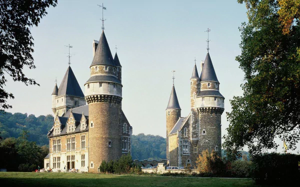 A picturesque view of Faulx-les-Tombes Castle in Namur, Belgium, showcasing its impressive architecture and surrounding greenery, captured as a high-definition desktop wallpaper.