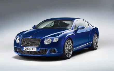 A blue Bentley Continental GT Speed coupé with a fastback design, showcased as an HD PC desktop wallpaper and background.