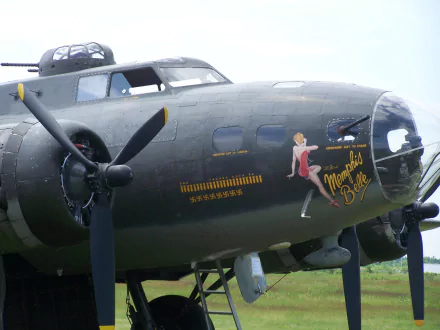 HD desktop wallpaper featuring the iconic Memphis Belle bomber from the movie, showcasing the aircraft's nose art and propellers in sharp detail.
