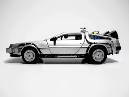 HD PC desktop wallpaper showing a monochrome side profile of the DeLorean time machine from the movie Back to the Future, with gullwing doors and rear flux components.