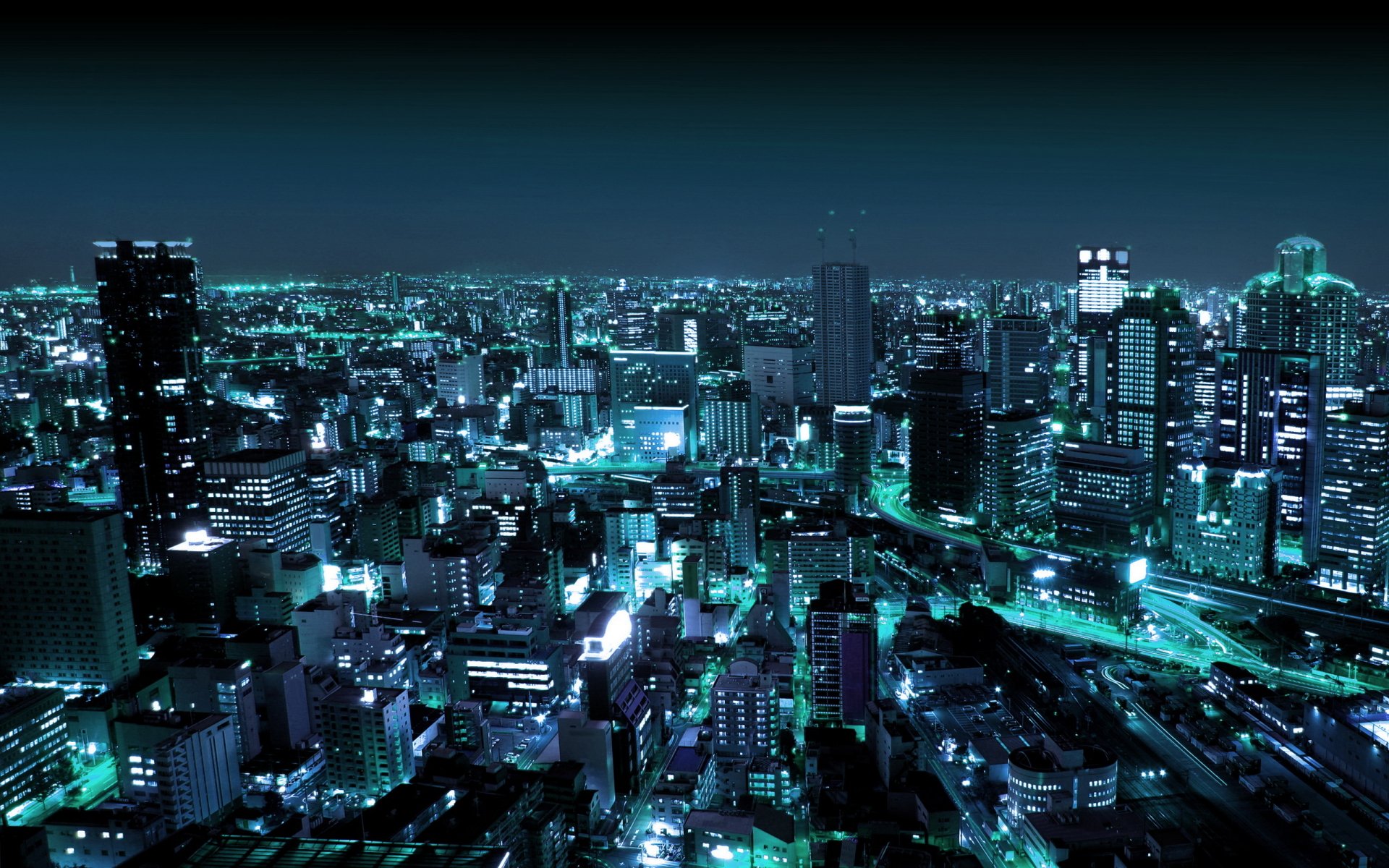 2K Quad HD PC desktop wallpaper of Osaka, Japan — a man-made nighttime cityscape bathed in teal-blue lights and dense urban high-rises.