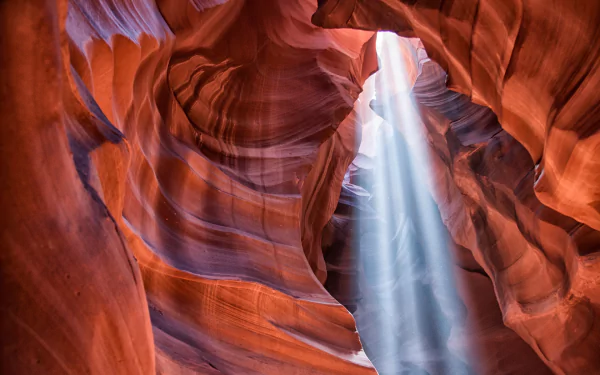 HD desktop wallpaper showcasing the stunning natural rock formations and light beams inside Antelope Canyon, highlighting the beauty of nature’s sculpted sandstone walls.