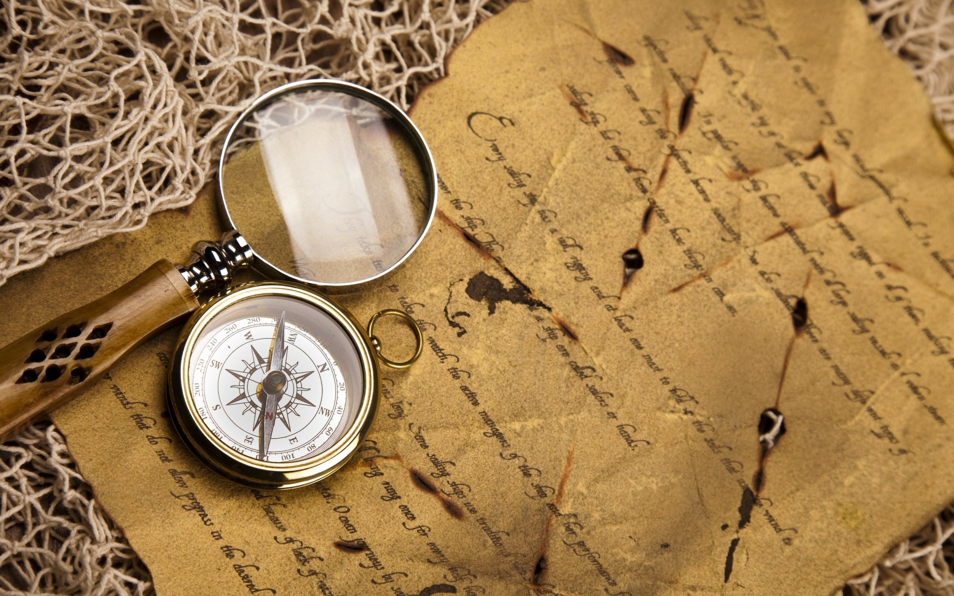 Vintage compass and magnifying glass resting on an aged, handwritten parchment, styled as a high-definition PC desktop wallpaper with a nostalgic photographic feel.