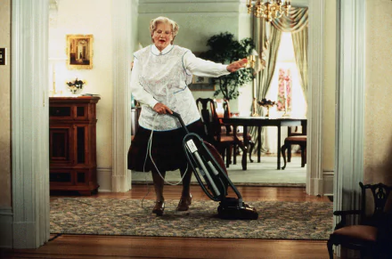 HD desktop wallpaper of Mrs. Doubtfire dancing with a vacuum cleaner in a well-furnished room.