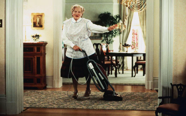 HD desktop wallpaper of Mrs. Doubtfire dancing with a vacuum cleaner in a well-furnished room.