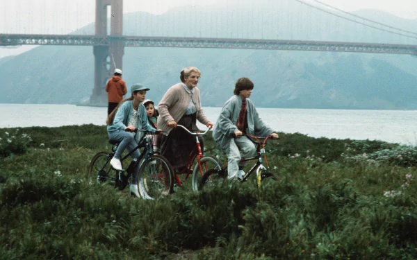 HD wallpaper of characters from Mrs. Doubtfire on a bike ride with the Golden Gate Bridge in the background.