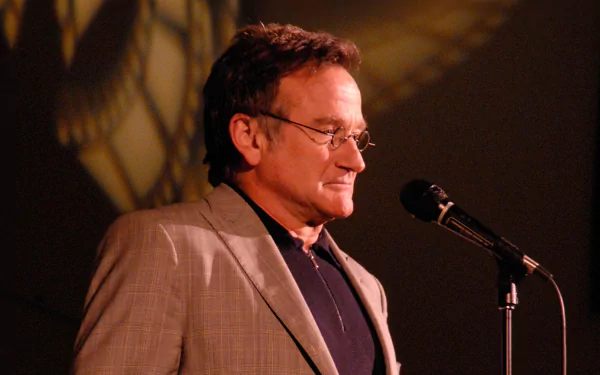 HD desktop wallpaper featuring a man at a microphone set against a warm, dimly lit background.
