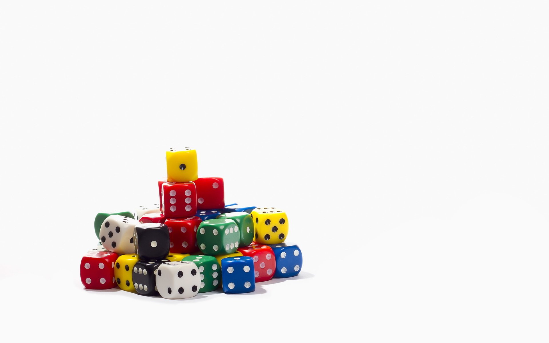 HD desktop wallpaper featuring a stack of colorful man-made dice against a clean white background.