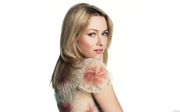 HD desktop wallpaper featuring Naomi Watts with a soft focus, showcasing her blonde hair and subtle makeup, exuding elegance and charm. A striking background for any screen.