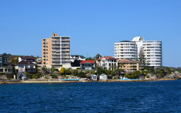 HD PC desktop wallpaper showing Sydney coast with man-made buildings and a manly waterfront skyline beneath a clear blue sky.