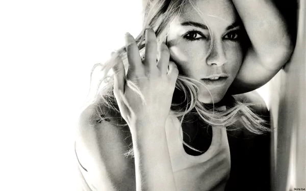 Black-and-white HD PC desktop wallpaper: close-up portrait of a female celebrity, hand framing her face and an intense, contemplative gaze.