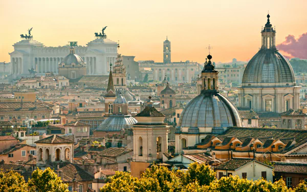 HD desktop wallpaper of Rome, featuring a breathtaking view of the city's historic architecture and iconic domes at sunset, highlighting the beauty of man-made structures.