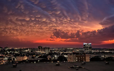 A stunning HD desktop wallpaper showcasing a vibrant sunset over Fort Worth, featuring dramatic clouds and a city skyline illuminated by city lights.