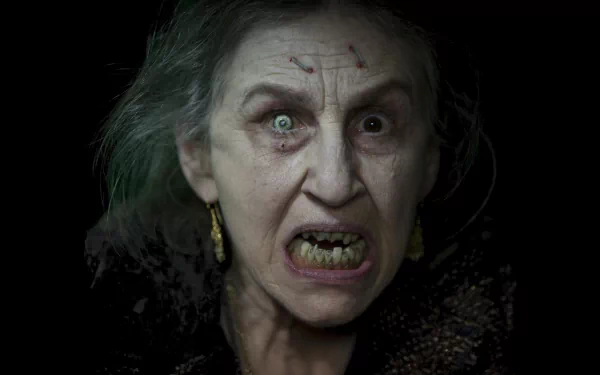 HD PC desktop wallpaper featuring a terrifying close-up from the movie Drag Me to Hell, capturing an exorcist-themed horror scene.