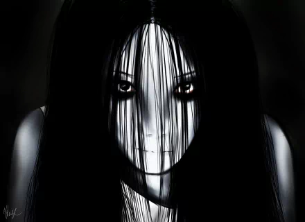 HD desktop wallpaper featuring a haunting close-up of Kayako from the 2004 horror movie The Grudge, with dark hair obscuring her pale, eerie face.