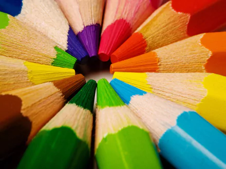 Close-up photography of sharpened colored pencils arranged in a circle, creating a vibrant, HD desktop wallpaper and background.