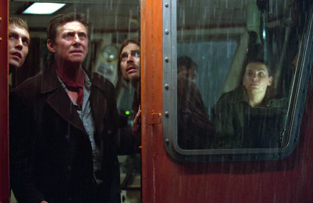 HD movie wallpaper featuring intense characters aboard a ghost ship, captured through a rain-speckled window for a moody, suspenseful atmosphere on a PC desktop background.