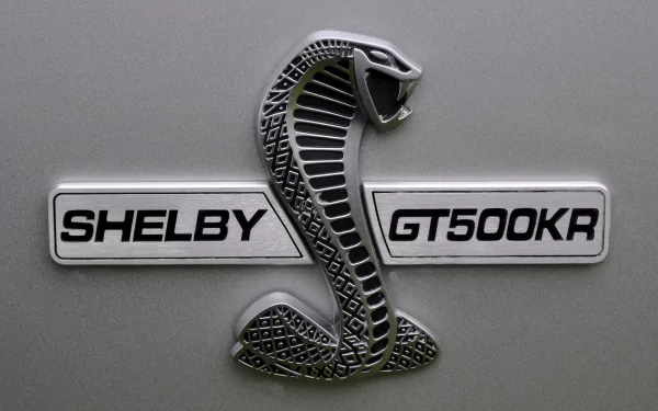 Close-up of the Shelby GT500KR emblem featuring a striking cobra design, showcasing the iconic branding of Ford Mustang vehicles in 4K Ultra HD quality.