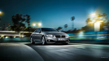 Silver BMW 4 Series Coupe vehicle speeding through lit city streets at night, motion-blurred HD PC desktop wallpaper/background.
