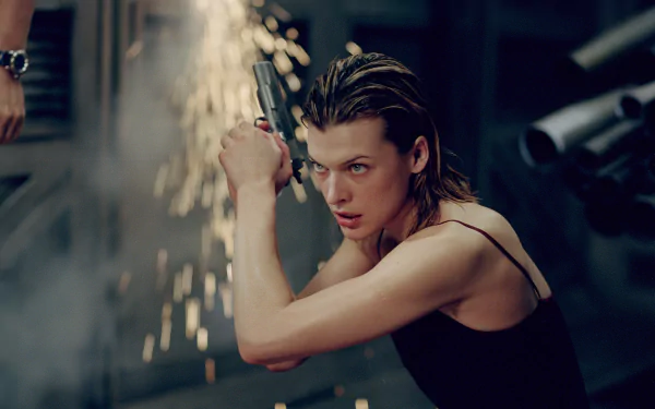 Milla Jovovich in an action-packed moment from the movie Resident Evil, showcasing intense energy with a gun, set against a backdrop of dynamic sparks and dark surroundings.