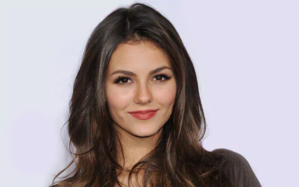 A vibrant HD desktop wallpaper featuring the celebrity Victoria Justice, showcasing her beautiful features and expressive smile against a soft background.