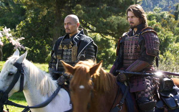 Two samurai warriors in traditional armor atop horses, set against a lush landscape, captured in a scene from the movie The Last Samurai. HD desktop wallpaper quality.